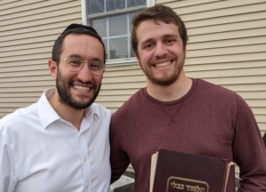 Rabbi and Student smiling at camera