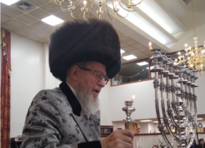 Rabbi lighting the Menorah