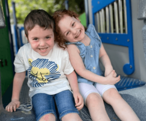 Boy and girl smiling on a playground